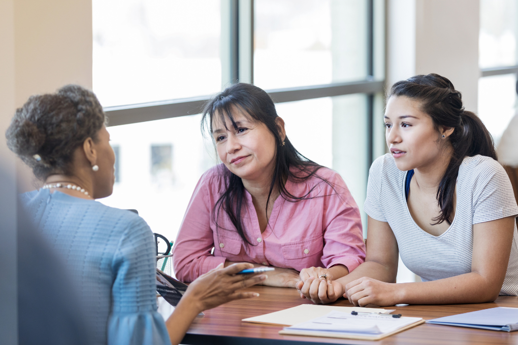 Loan officer explains loan application process with clients