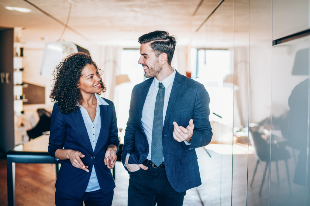 Man and woman discussing business in office.
