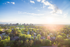 Bird's eye view of houses while the sun rises.